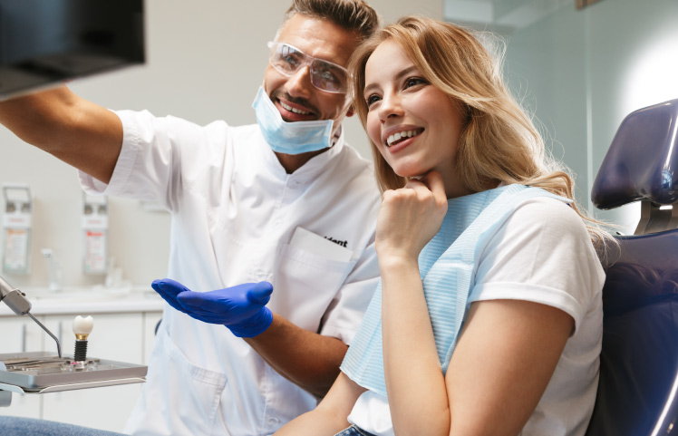 dentist showing patient computer screen